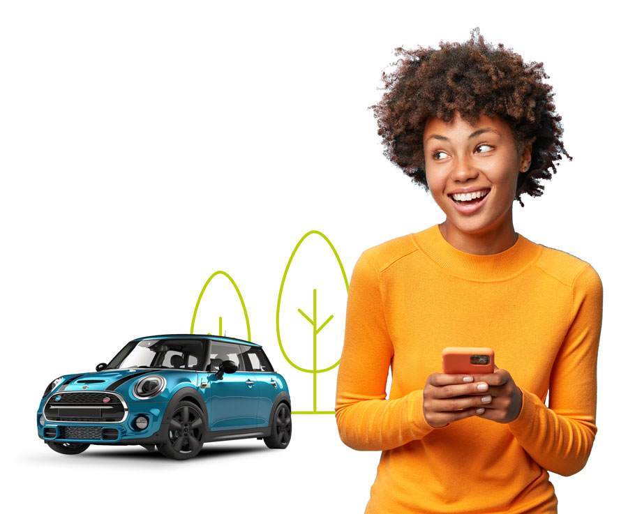 Smiling lady in yellow jumper holding phone and looking at blue mini cooper in background